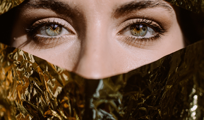 Photo by Cole Keister: https://www.pexels.com/photo/woman-behind-gold-paper-2388647/