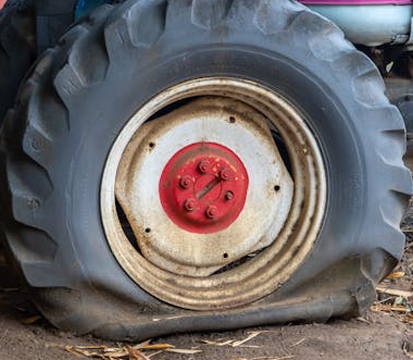 Photo by Magda Ehlers: https://www.pexels.com/photo/a-flat-tire-on-a-heavy-equipment-9349144/